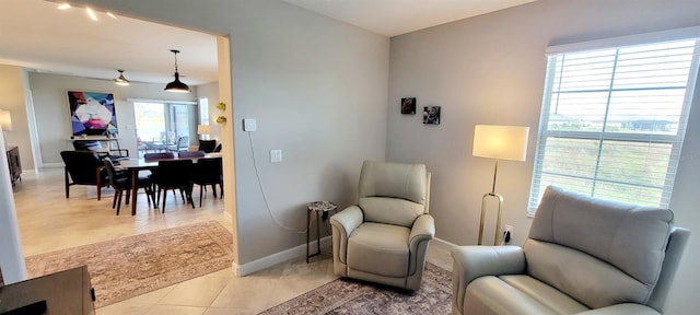 living area with light tile patterned floors and plenty of natural light