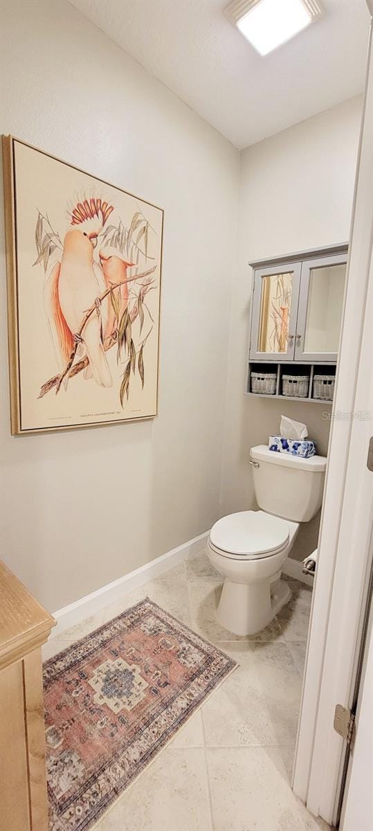 bathroom featuring tile patterned floors and toilet