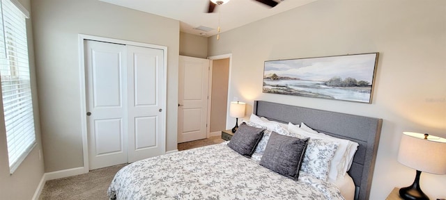 bedroom with ceiling fan, a closet, and light carpet