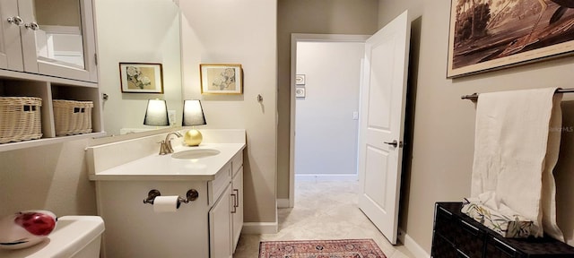 bathroom featuring toilet, vanity, and tile patterned flooring