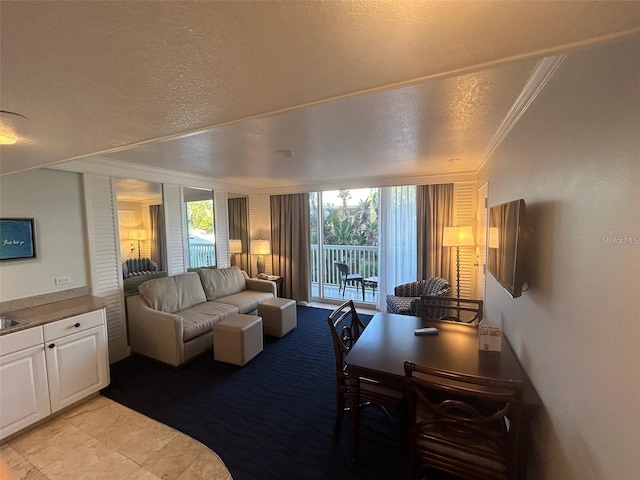 living room featuring ornamental molding and a textured ceiling