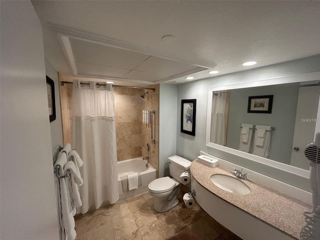 full bathroom featuring shower / bath combo, vanity, a textured ceiling, and toilet