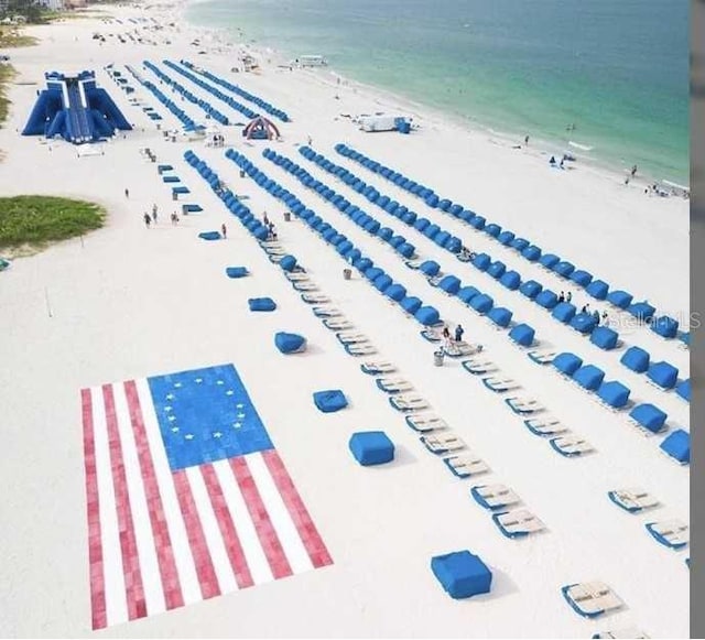 bird's eye view featuring a water view and a beach view