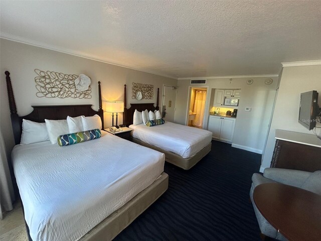 5500 Gulf Blvd Unit 2237, St Pete Beach, FL 33706 - bedroom featuring ornamental molding, a textured ceiling, and carpet floors
