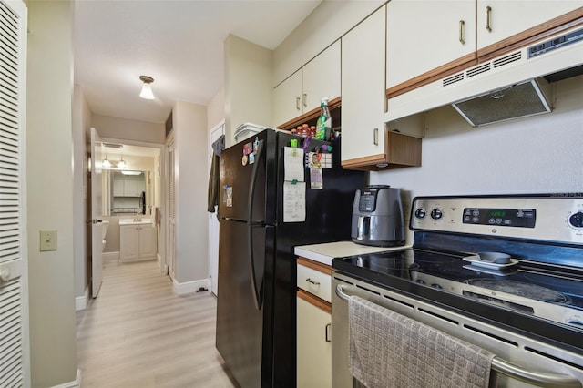 kitchen featuring white cabinets, electric range, light hardwood / wood-style floors, and black refrigerator