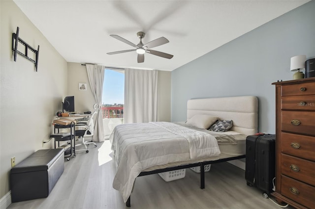 bedroom with light hardwood / wood-style flooring and ceiling fan