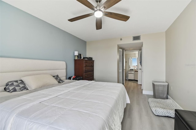 bedroom with light wood-type flooring and ceiling fan