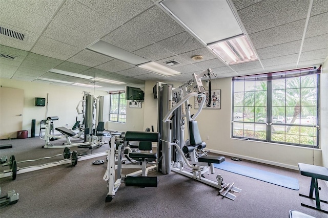 exercise room with a paneled ceiling