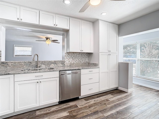 kitchen with dishwasher, white cabinets, and plenty of natural light