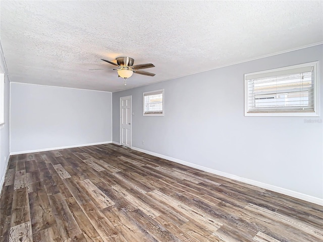 empty room featuring dark wood-type flooring, ceiling fan, and a textured ceiling