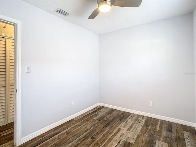 empty room featuring dark hardwood / wood-style floors and ceiling fan