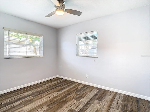 unfurnished room with ceiling fan, a wealth of natural light, and dark hardwood / wood-style floors