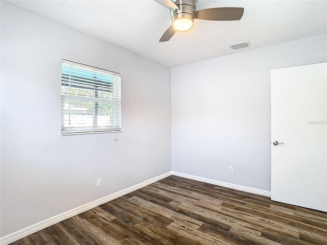 unfurnished room with dark hardwood / wood-style flooring and ceiling fan