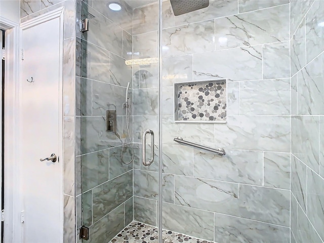 bathroom featuring a shower with shower door