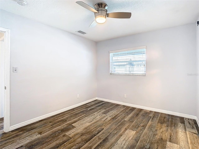 empty room featuring ceiling fan and dark hardwood / wood-style floors