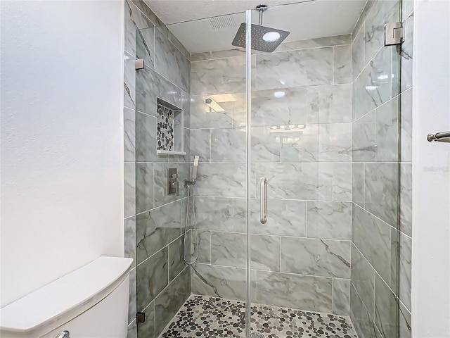 bathroom with walk in shower and toilet