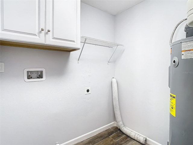 clothes washing area featuring hookup for an electric dryer, hookup for a washing machine, dark hardwood / wood-style floors, water heater, and cabinets