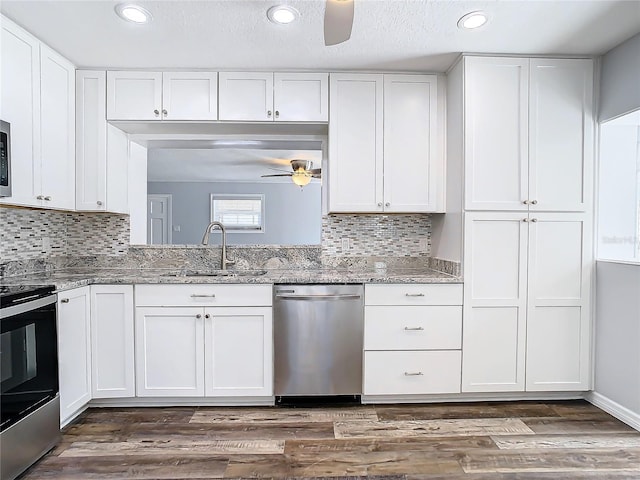 kitchen featuring white cabinetry, appliances with stainless steel finishes, sink, and dark hardwood / wood-style flooring