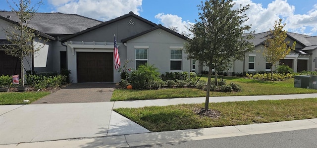 view of front of home with a front lawn and a garage