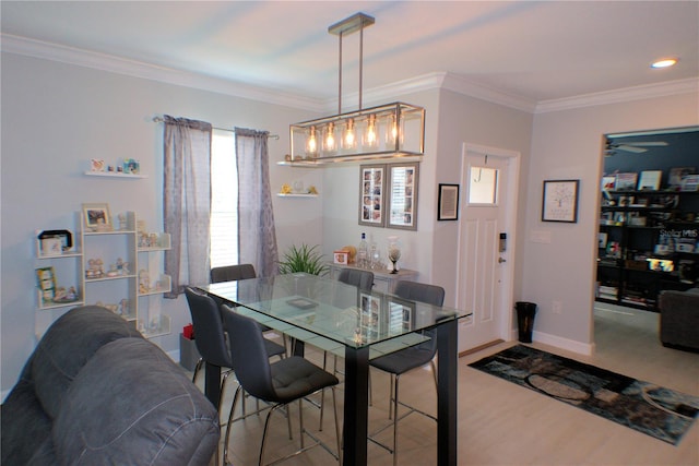 dining room featuring hardwood / wood-style floors, ceiling fan, and ornamental molding