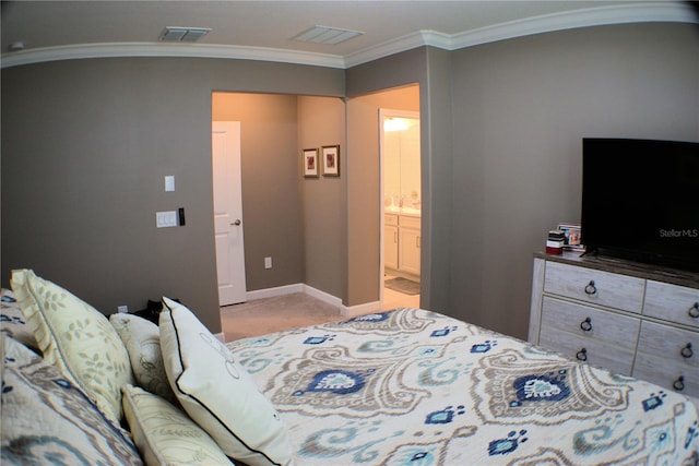 bedroom featuring ensuite bath, light colored carpet, and crown molding