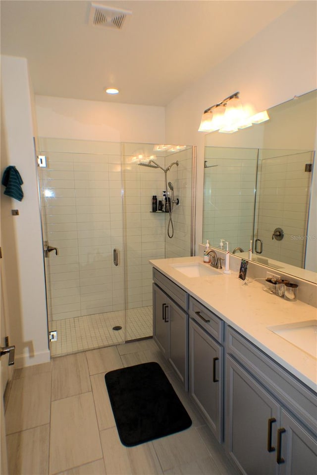 bathroom featuring walk in shower and vanity