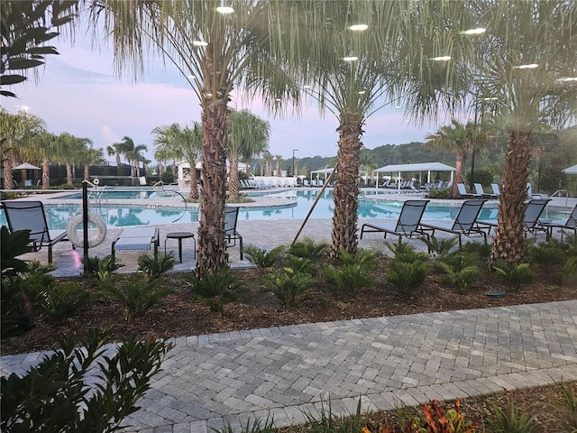 view of pool at dusk