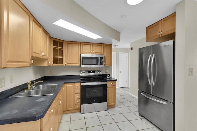 kitchen with sink, light tile patterned flooring, and stainless steel appliances