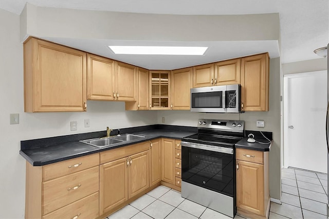 kitchen featuring appliances with stainless steel finishes, sink, and light tile patterned floors