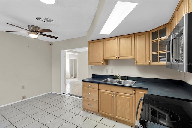 kitchen featuring black electric range, sink, ceiling fan, and light tile patterned floors