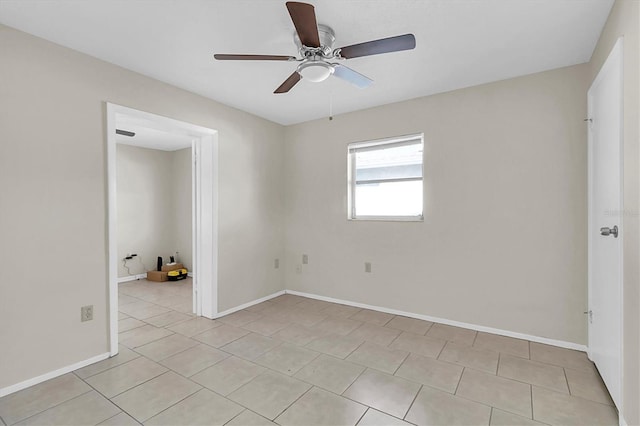 tiled empty room featuring ceiling fan