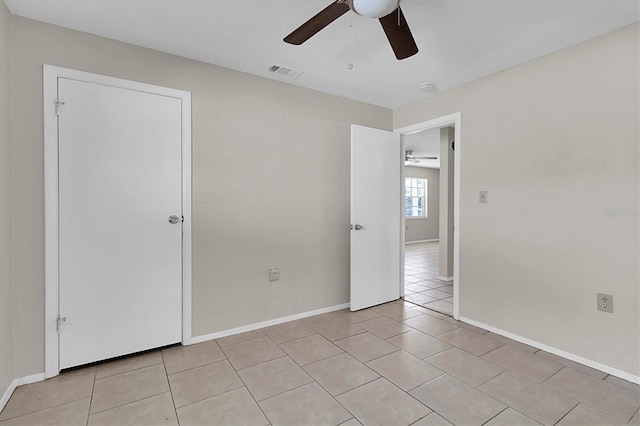 unfurnished bedroom featuring ceiling fan and light tile patterned floors