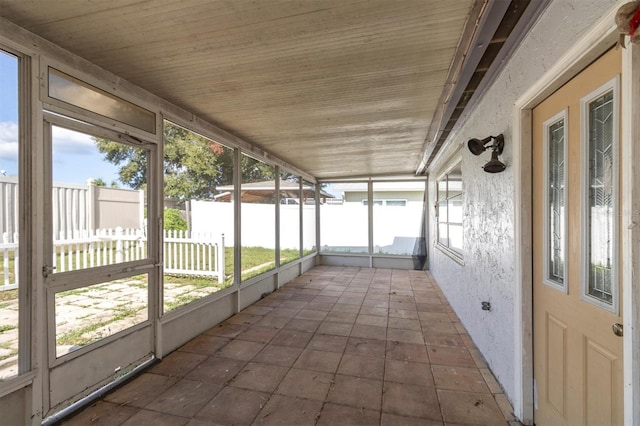 unfurnished sunroom with plenty of natural light