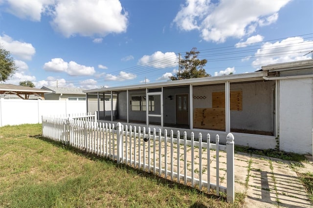 back of property with a sunroom