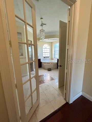 hallway featuring light tile patterned floors and french doors