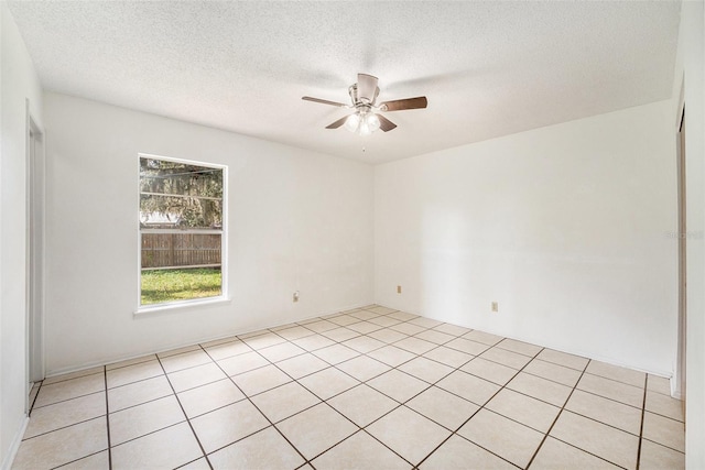 unfurnished room featuring a textured ceiling, light tile patterned floors, and ceiling fan