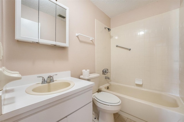 full bathroom with tile patterned floors, vanity, a textured ceiling, toilet, and tiled shower / bath