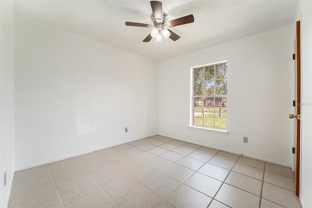 unfurnished room featuring a textured ceiling, ceiling fan, and light tile patterned floors