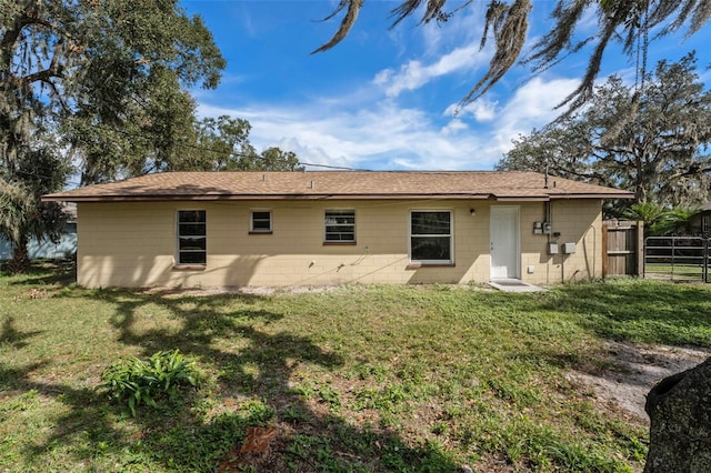 rear view of property with a lawn