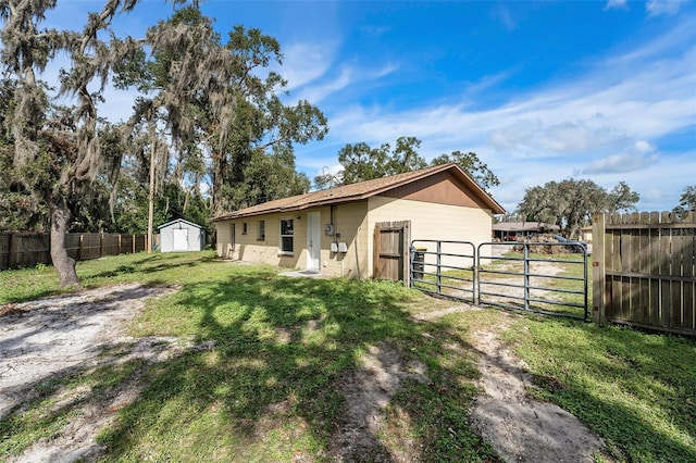 exterior space with a shed and a front lawn