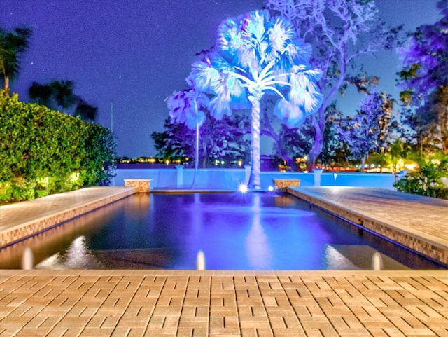 view of pool at night