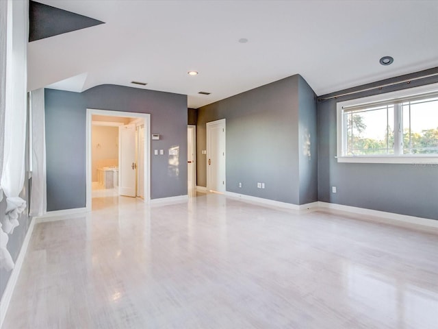 spare room featuring light hardwood / wood-style flooring