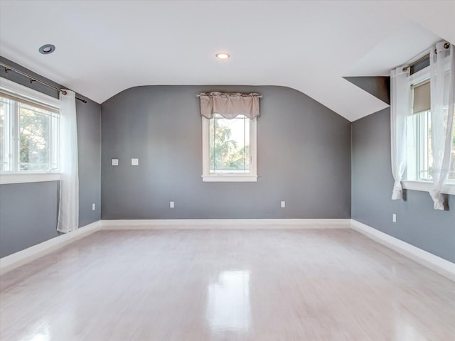 additional living space with wood-type flooring and lofted ceiling