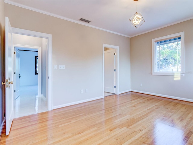 unfurnished room with crown molding and light hardwood / wood-style floors