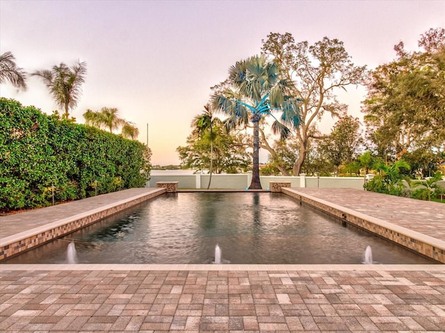 view of pool at dusk