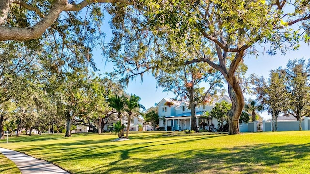 view of property's community featuring a yard