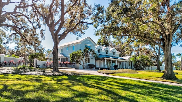 view of front of house with a porch and a front yard