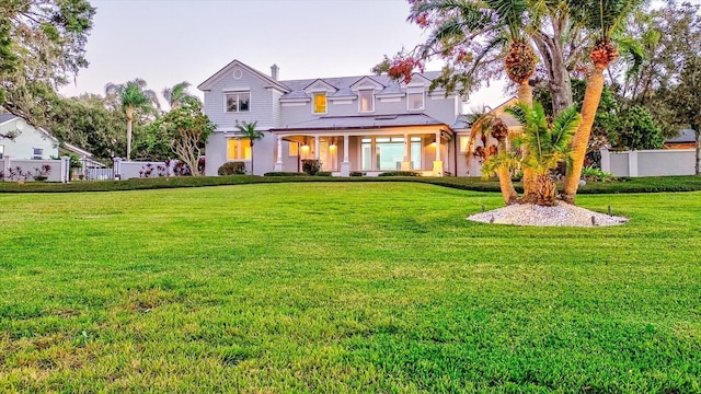 view of front of house featuring a front yard and fence