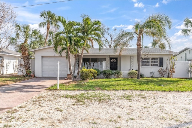 single story home with a front yard and a garage