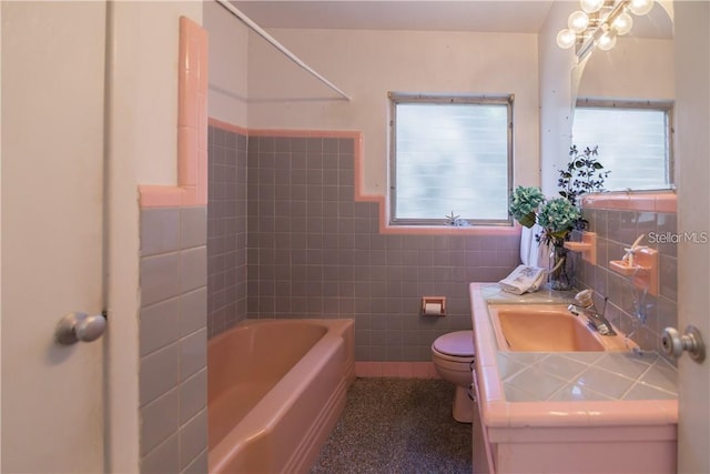 full bathroom with shower / tub combination, vanity, tile walls, and toilet